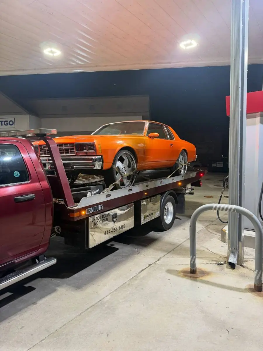 Classic orange coupe loaded on a PS Towing rollback